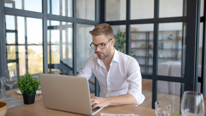 man sitting at desk in office typing